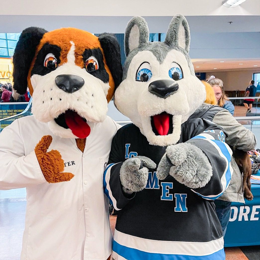 Forever Vets dog mascot posing with Jacksonville Icemen dog mascot