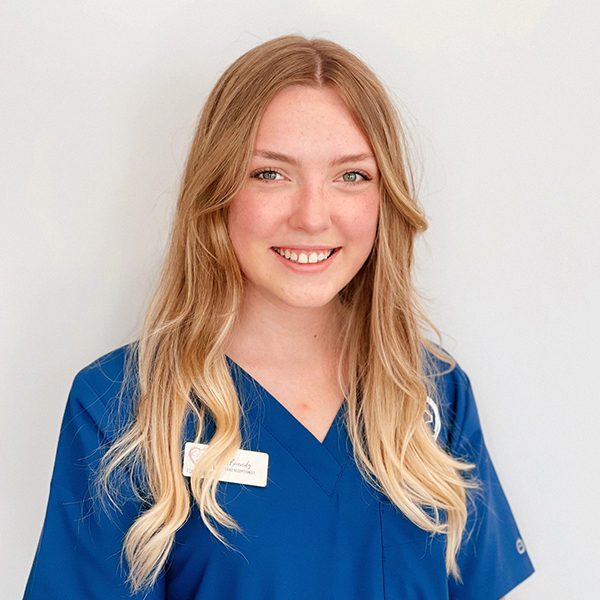 Brandy Lathrop wearing blue scrubs and smiling at the camera