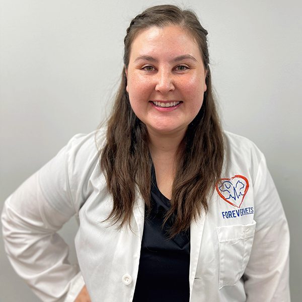 Dr. Maggie Heiar wearing a white lab coat and smiling at the camera