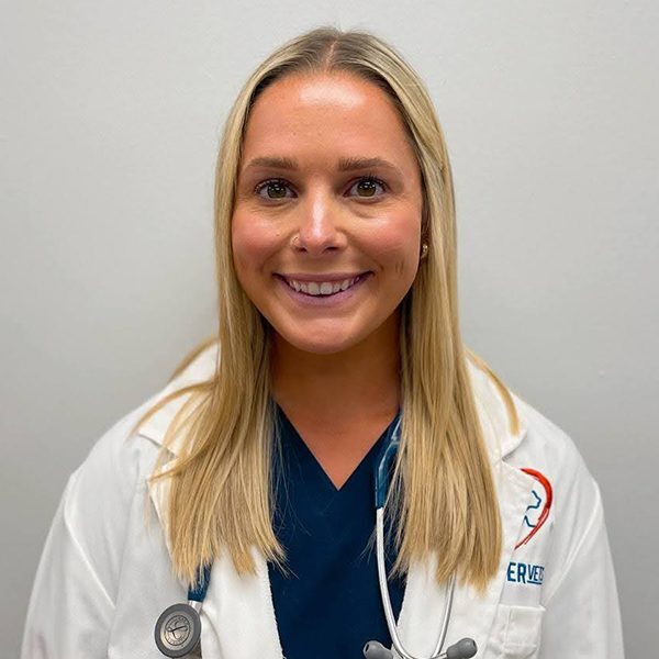 Dr. Sydney Orr wearing a white lab coat and smiling at the camera