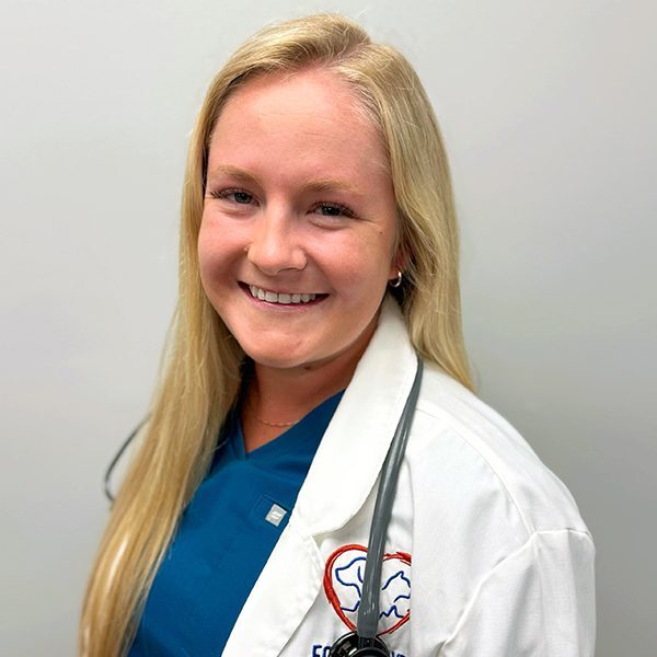 Dr. Syler Carstairs wearing a white lab coat and smiling at the camera
