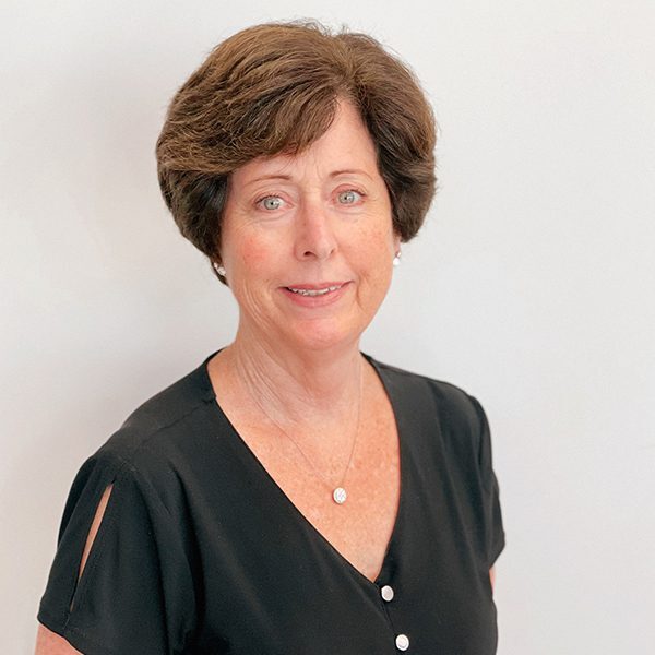 Jane Schaefer wearing a black top and smiling at the camera