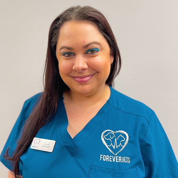 Sarah Papke wearing blue scrubs and smiling at the camera