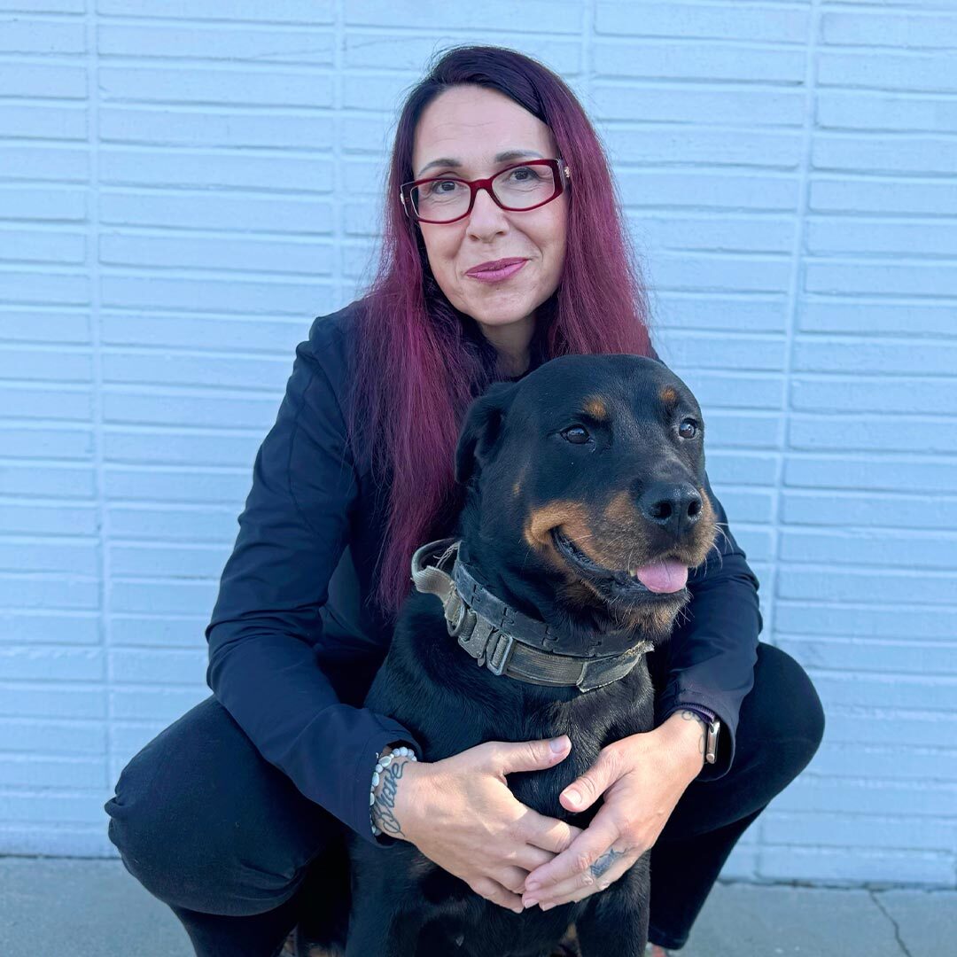 Dr Anita Varga hugging her black and brown dog