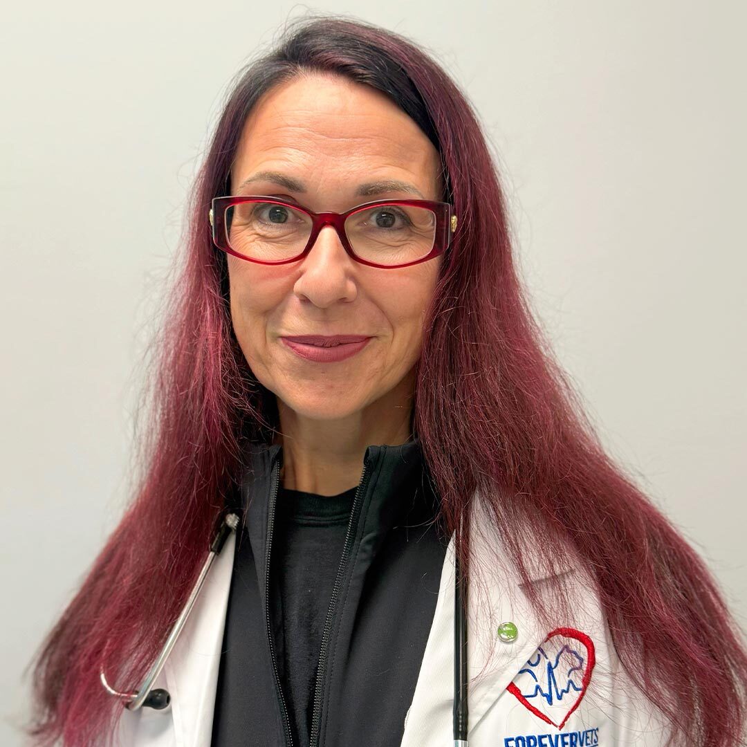 Dr Anita Varga wearing a white coat and smiling at the camera