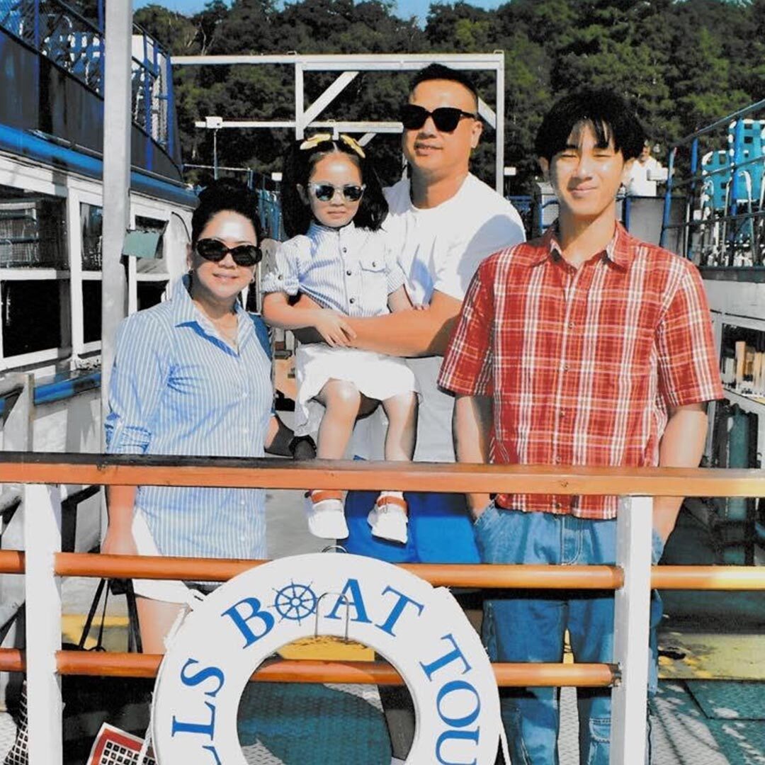Dr Christian Legaspi with family on the back of a boat