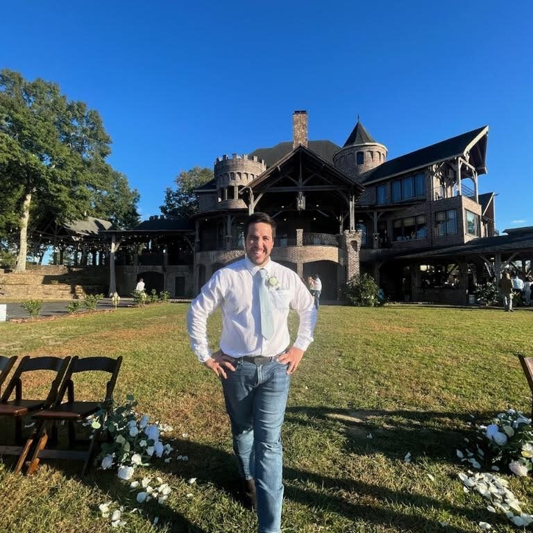 Dr Guzman standing outside of a home