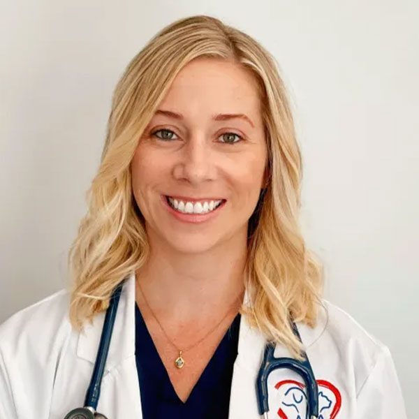 Dr Kelly Labinsky wearing a white lab coat and smiling at the camera