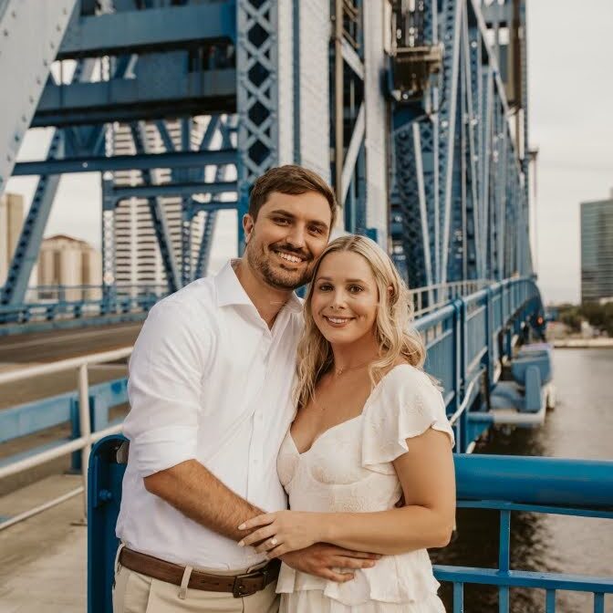 Dr Orr smiling with a man on a bridge