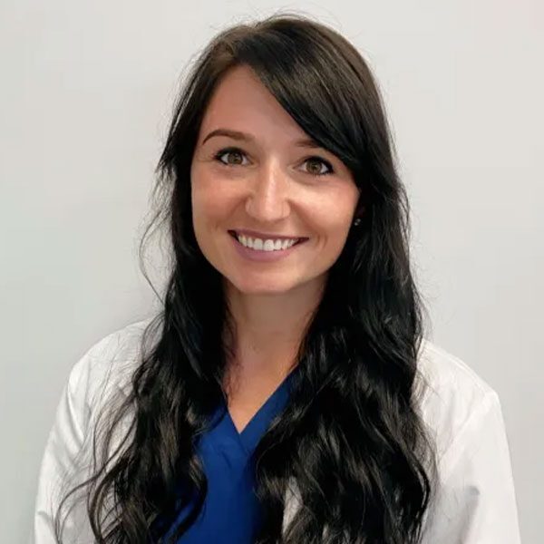Dr Paige Watson wearing a white lab coat and smiling at the camera