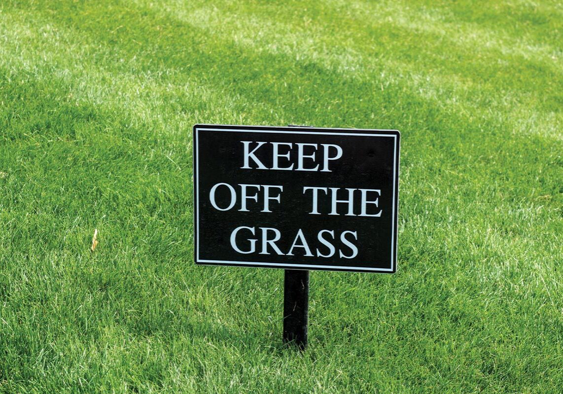 sign in grass that says "keep off the grass"