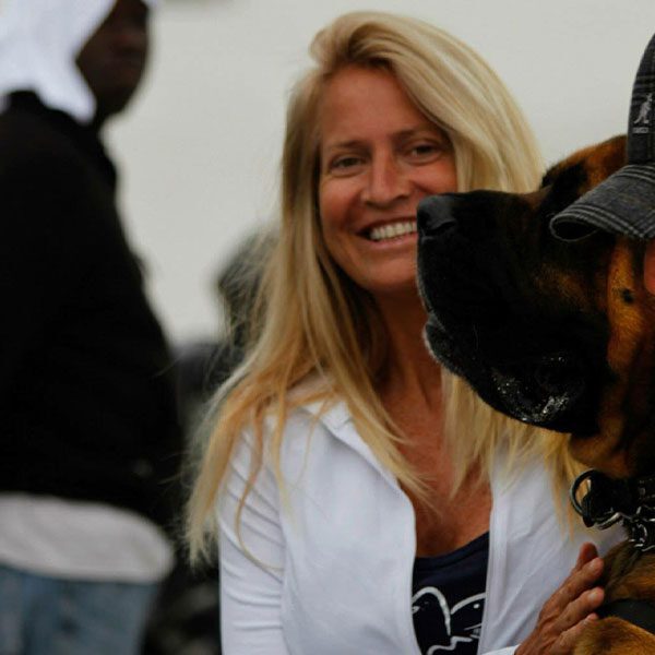 Magi Foster smiling next to a dog